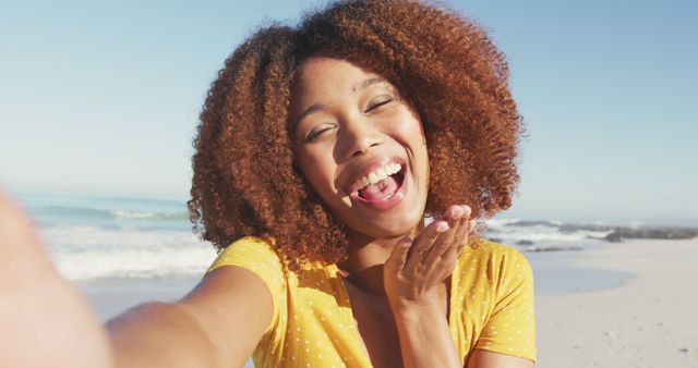 Happy Woman Blowing Kiss at Beach on Sunny Day - Download Free Stock Images Pikwizard.com