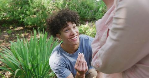 Man Proposing with Ring in Sunny Garden