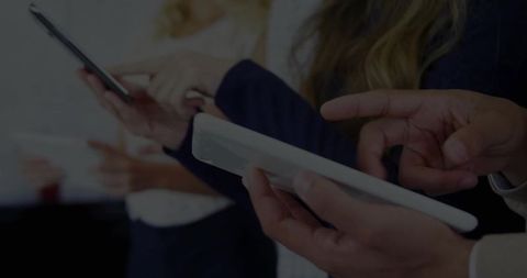 Professionals Utilizing Mobile Devices in Modern Office Collaboration