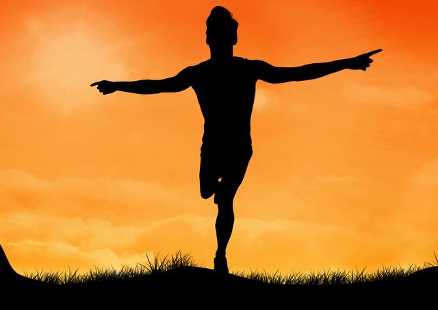 Silhouette of a man standing on one leg with arms outstretched against a vibrant sunset sky. Ideal for concepts of balance, tranquility, and nature. Suitable for use in wellness, meditation, and outdoor activity promotions.