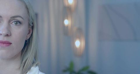 Contemplative mid adult woman in modern decor office