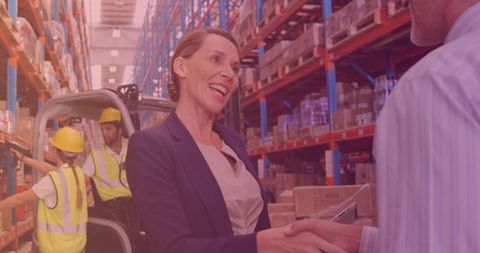 Professional Businesswoman Shaking Hands in Warehouse Collaborative Environment - Download Free Stock Images Pikwizard.com