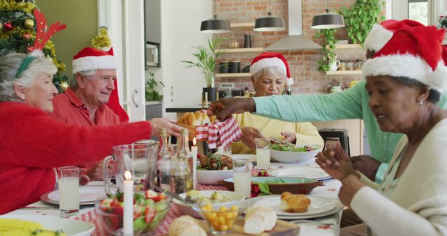 Group of happy diverse senior friends in santa hats making a toast at christmas dinner table at home. retirement lifestyle, christmas festivities, celebrating at home with friends.
