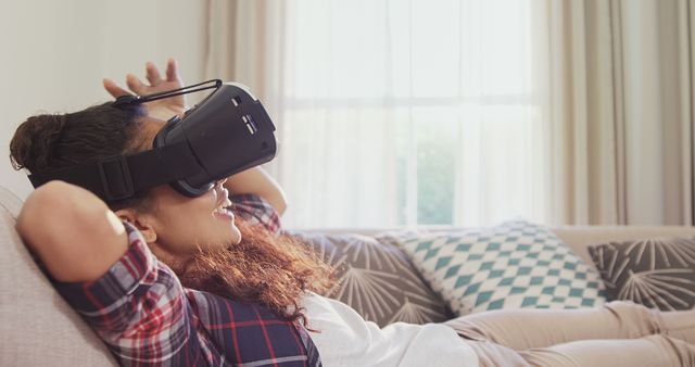 Young Woman Relaxing on Couch Using VR Headset - Download Free Stock Images Pikwizard.com