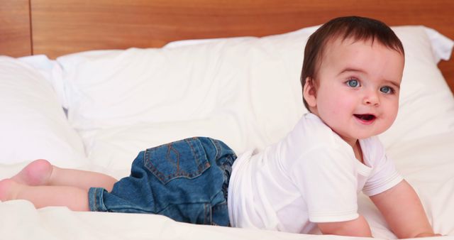 Adorable Baby Boy Smiling on Bed in Casual Outfit - Download Free Stock Images Pikwizard.com