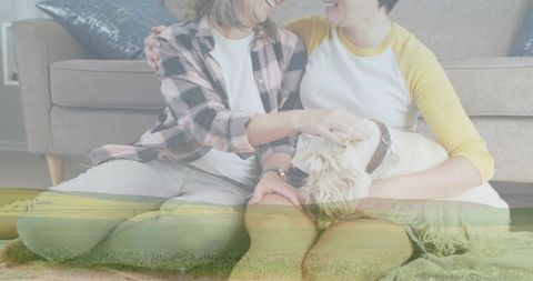 Female couple sitting on living room floor petting white dog with grassy double exposure