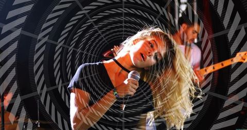 Female lead singer rocking wired microphone with spiral motion overlay, live energy