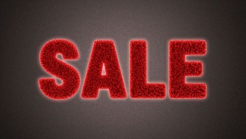 Glowing red plush sale letters on dark grainy background for retail promotion