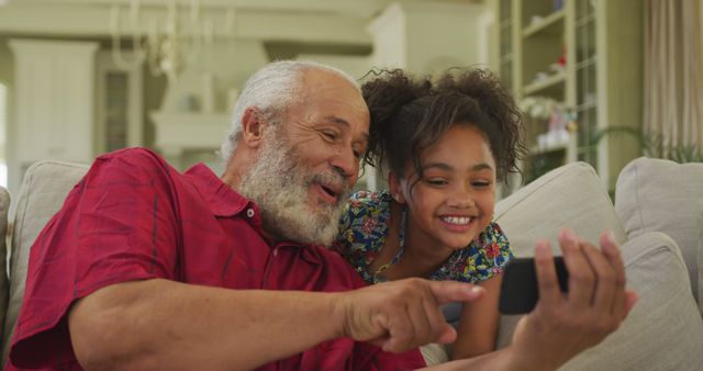 Senior Man and Smiling Granddaughter Using Smartphone Together at Home - Download Free Stock Images Pikwizard.com