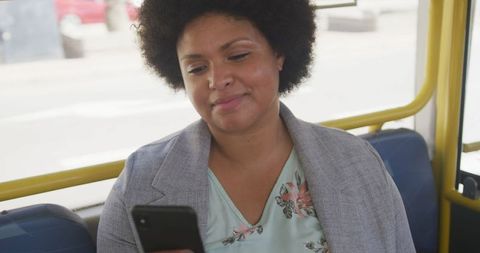 Smiling Plus Size Woman Using Smartphone on Public Bus