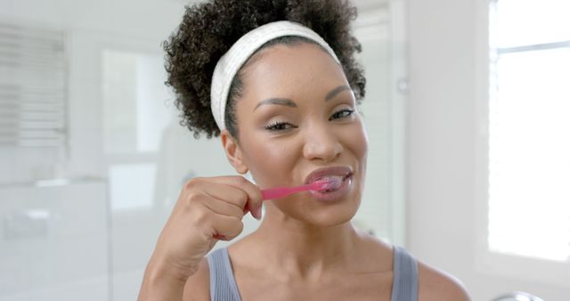 Smiling Young Woman Brushing Teeth in Bright Bathroom - Download Free Stock Images Pikwizard.com