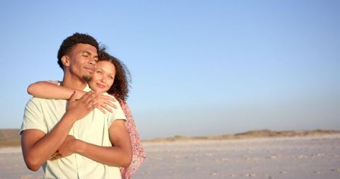 Couple Embracing on Peaceful Sunlit Beach Getaway