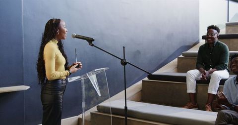 Confident Woman Presenting to Colleagues in Modern Workspace
