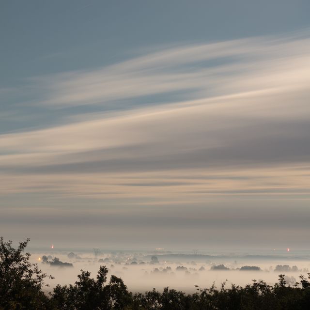 Serene Distant Town with Low Hanging Fog during Sundown - Download Free Stock Images Pikwizard.com