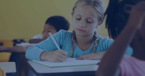 Focused Elementary Student Writing in Class