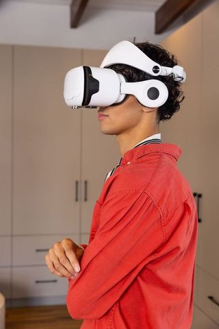 Man Experiencing Virtual Reality with White VR Headset in Modern Kitchen