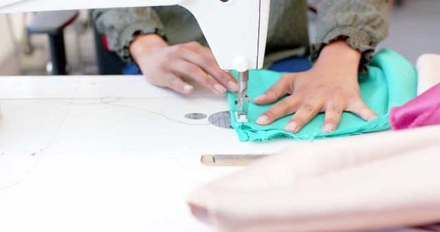 Tailor Working on Sewing Machine with Green Fabric - Download Free Stock Images Pikwizard.com