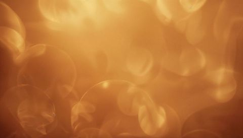 Glowing Golden Bokeh Orbs Abstract Background with Soft Amber Light and Circular Bloom