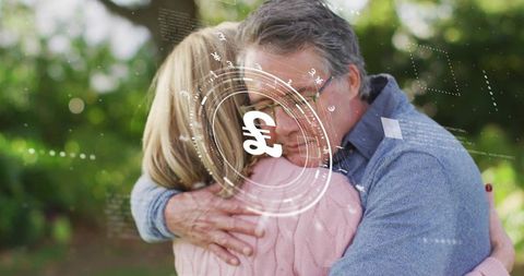 Senior couple embracing in garden wearing glasses with pound currency hud overlay