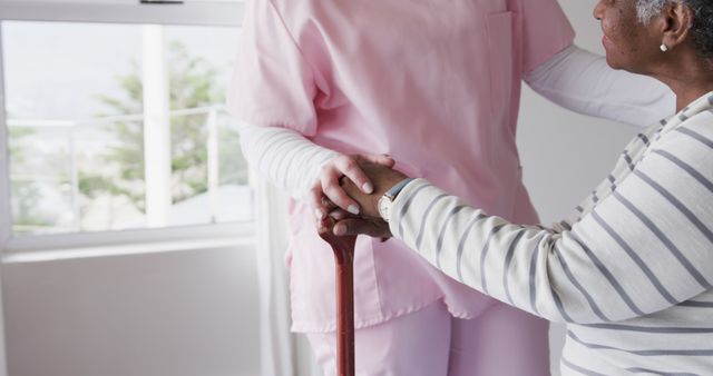 Senior Nurse Assisting Elder with Cane in Rehabilitation Center - Download Free Stock Images Pikwizard.com