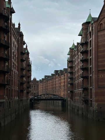 Historic Red Brick Warehouse Canal Lined with Bridges and Narrow Waterway in Hamburg