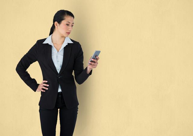 Digital composite of Businesswoman holding mobile phone over beige background