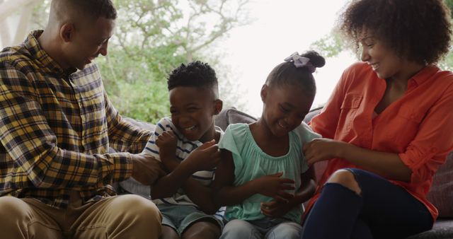 Happy African American Family Tickling and Laughing on Couch - Download Free Stock Images Pikwizard.com