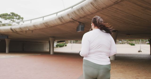 Woman as carefree energizing between urban jogging - Download Free Stock Images Pikwizard.com