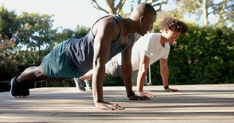 Diverse Male Athletes Doing Outdoor Push-Ups Wearing Fitness Gear