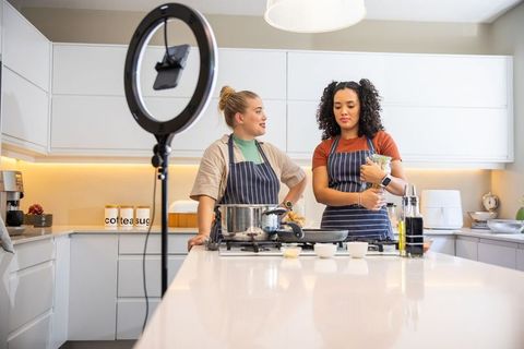 Diverse Female Friends Filming Cooking Show in Modern Home Kitchen
