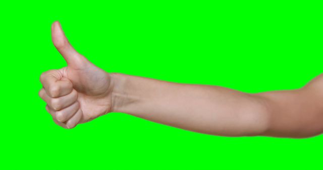 Image features a person's arm and hand giving a thumbs-up gesture on a green screen background. This image is perfect for symbolizing positivity, approval, or success in presentations, marketing materials, or as a cut-out element in design projects where the background can be easily removed or replaced.
