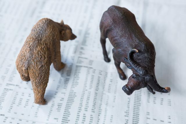 Bear and bull figures on financial data represent market trends. Ideal for illustrating stock market concepts, investment strategies, and economic analysis.