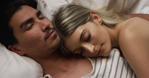 Peaceful couple napping in bedroom comfort