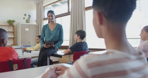 Teacher Engaging with Students in Classroom Fostering Active Learning