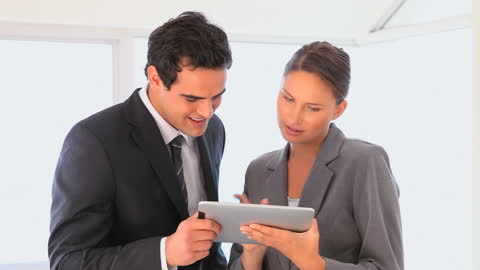 Colleagues Collaborating on Tablet in Office