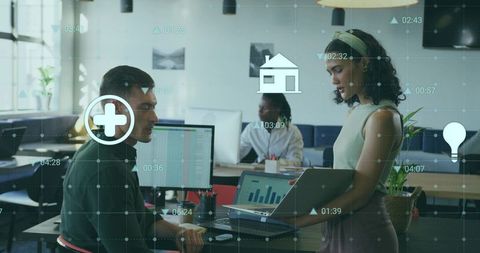 Office workers collaborating on data analysis with digital interface