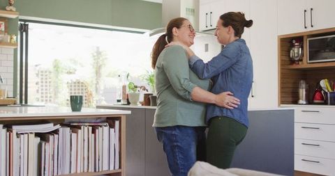 Caucasian Lesbian Couple Dancing Joyfully at Home