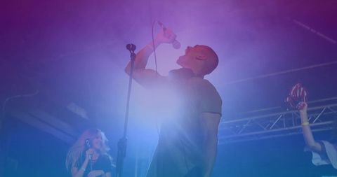 Dynamic Stage Performance with Colorful LED Lighting and Energetic Musicians