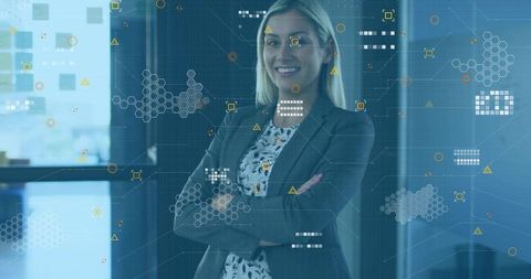 Confident executive woman standing arms crossed in office with digital interface overlays
