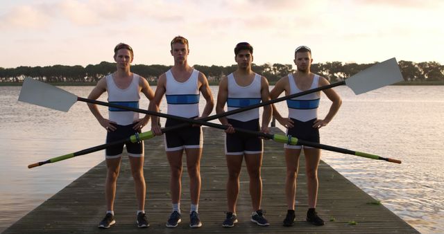 Competitive Male Rowers Holding Oars on Dock at Sunset - Download Free Stock Images Pikwizard.com