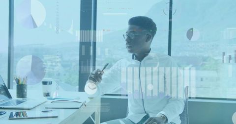 Businessman analyzing data with interactive charts in modern office