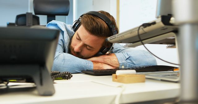 Office Worker Sleeping with Headphones at Desk - Download Free Stock Images Pikwizard.com