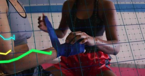 Wrapping boxing hand wraps on training partner with digital HUD overlay for boxing prep