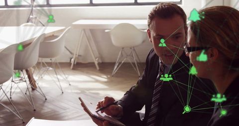 Business Professionals Analyzing Digital Networks in Modern Office