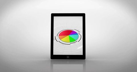 Tablet displaying colorful pie chart with futuristic hud rings on glossy reflective surface