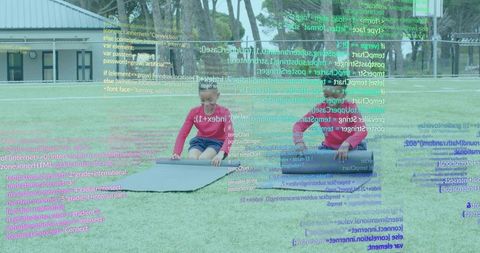 Boys unrolling mats on field with digital interface overlay