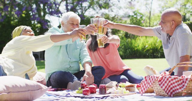 Senior friends celebrate with a toast at a sunny garden picnic, embodying active aging. - Download Free Stock Photos Pikwizard.com