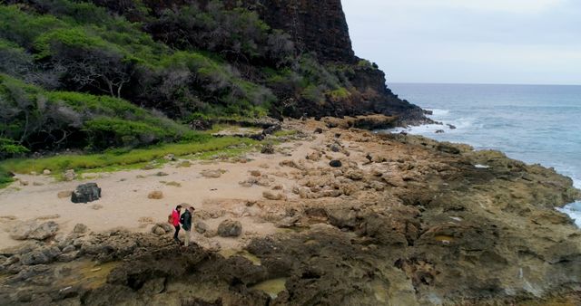 Drone view of caucasian couple walking in coastline with copy space - Download Free Stock Photos Pikwizard.com