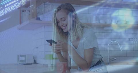 Smiling woman scrolling smartphone in bright kitchen with mug and digital tech overlay