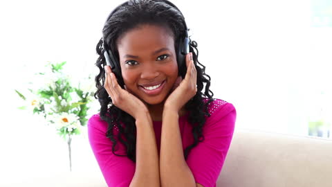 Joyful Woman Relaxing with Music Indoors